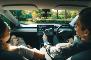 a-couple-sitting-in-an-ev-car-while-charging